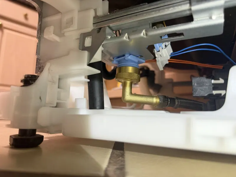 Water inlet elbow fitting at the dishwasher base