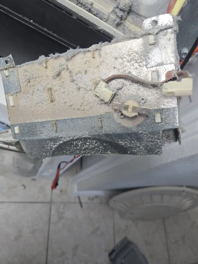 Lint-covered heating element assembly