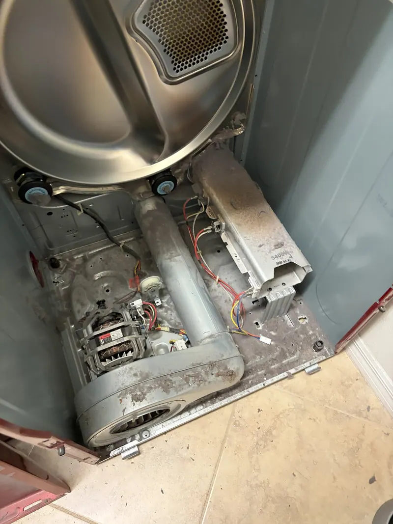 LG dryer opened up, with the motor, blower and heater visible