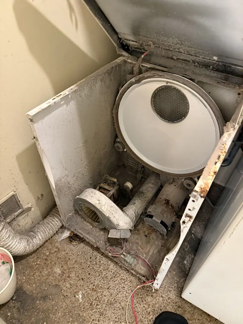 Opened Maytag dryer with the drum and blower motor