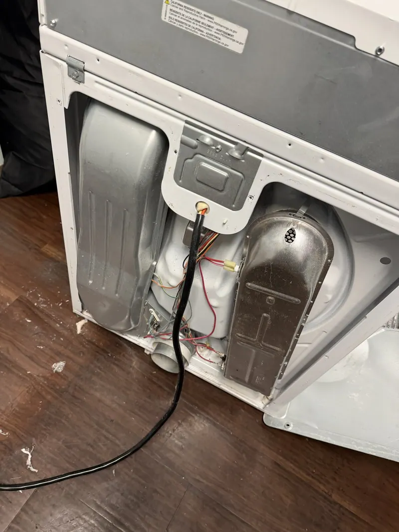 Exposed wiring on the back of the dryer
