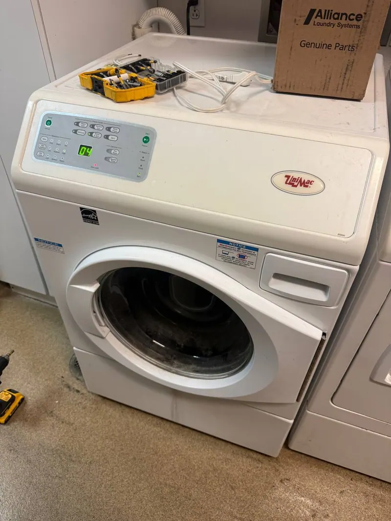 Commercial washer with tools and a parts box on top