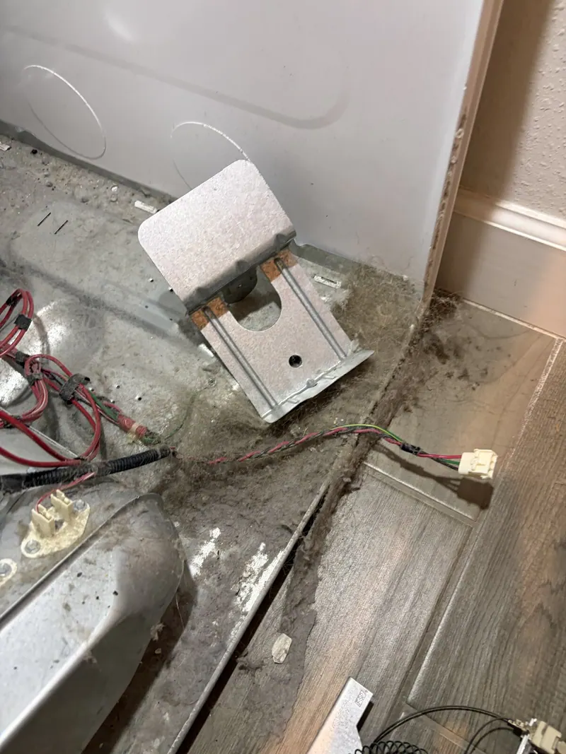 Dust on a metal bracket inside the dryer
