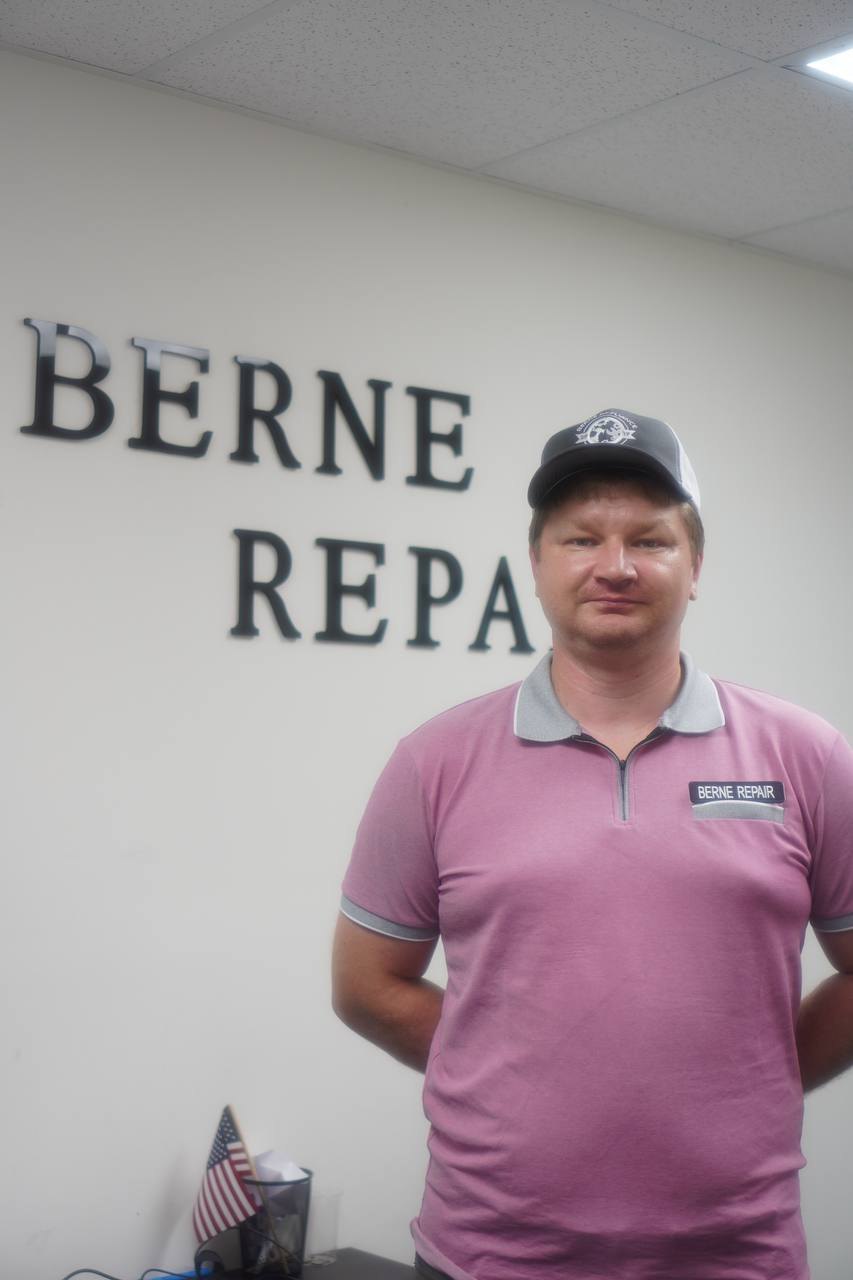 Berne Appliance Repair technician in BERNE REPAIR-branded uniform at the company office in South Florida