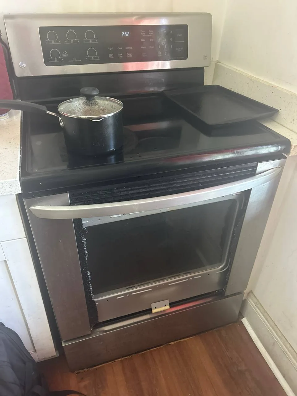 A stainless steel oven with its door removed in a kitchen setting