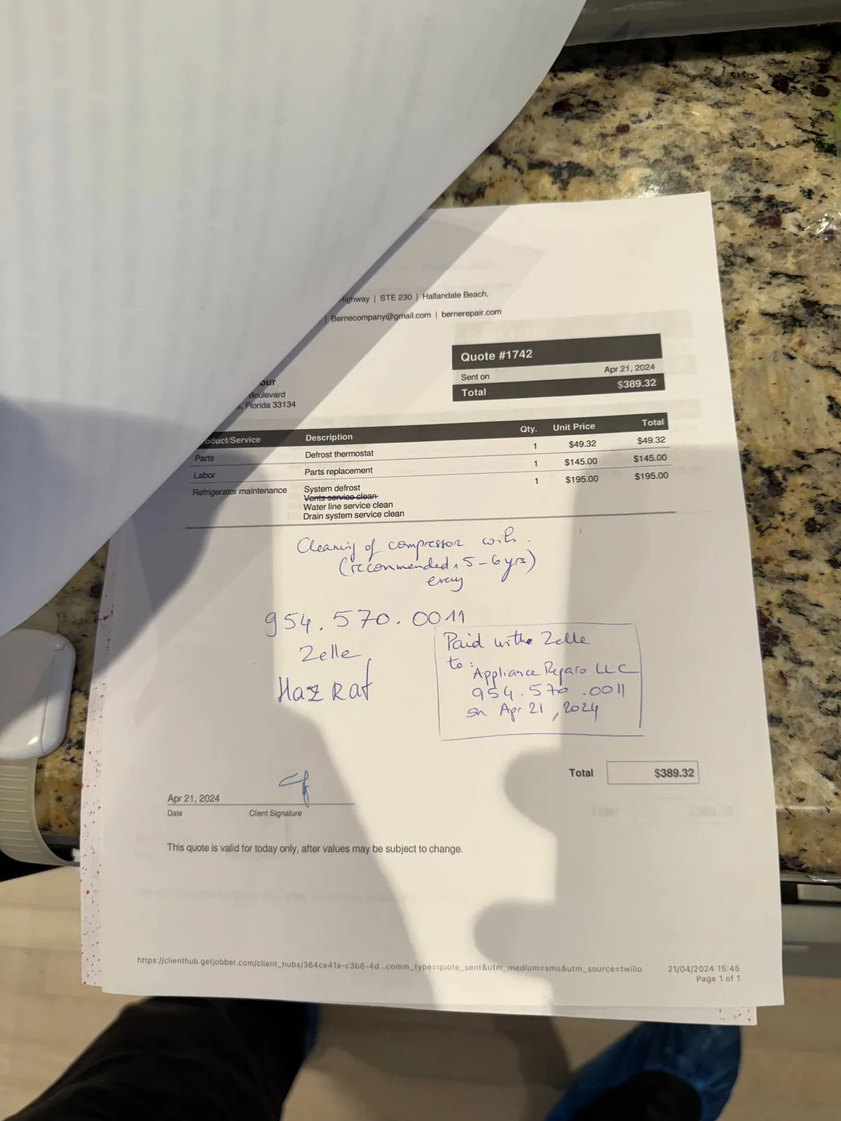 A service quote for refrigerator maintenance, including parts and labor, on a countertop