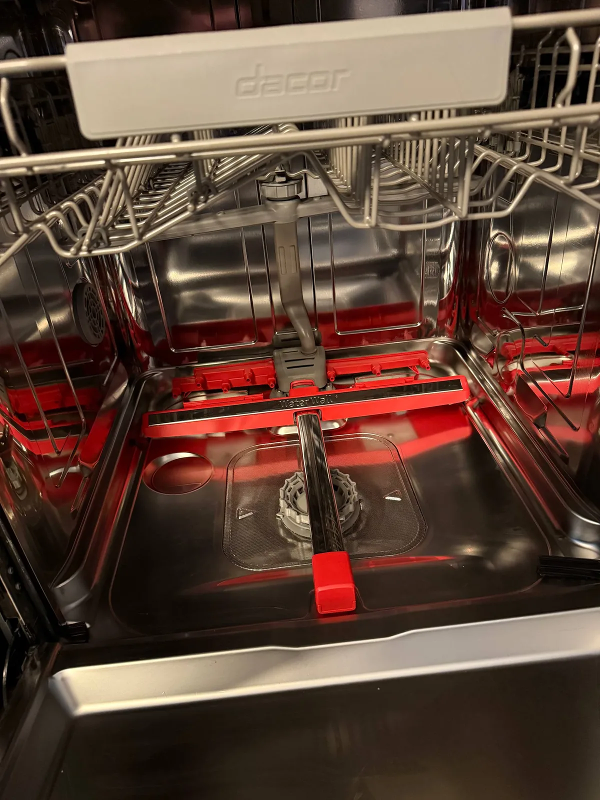 An inside shot of a Dacor dishwasher, showing the racks and interior