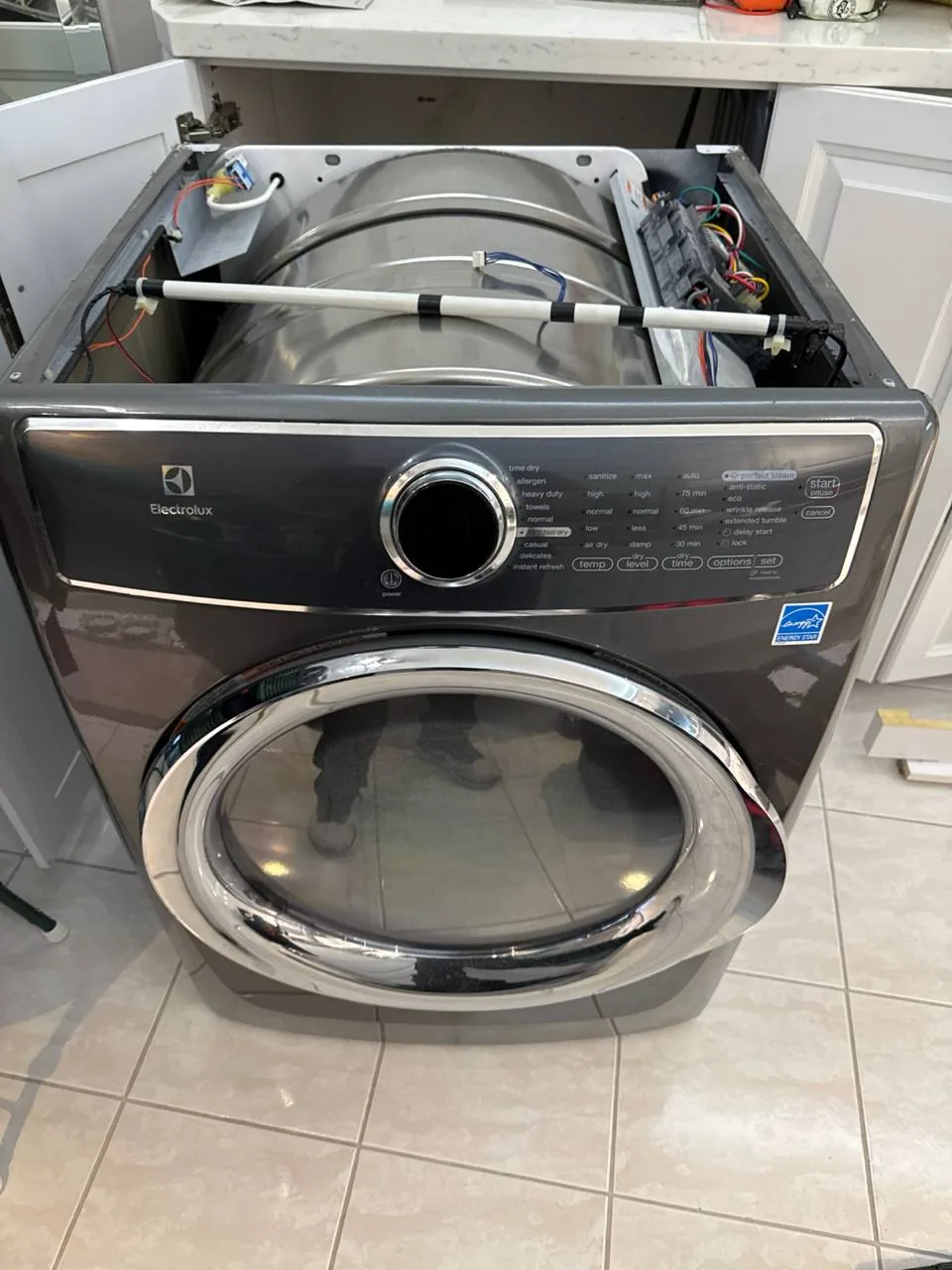 The an Electrolux dryer with its top panel removed, exposing internal components