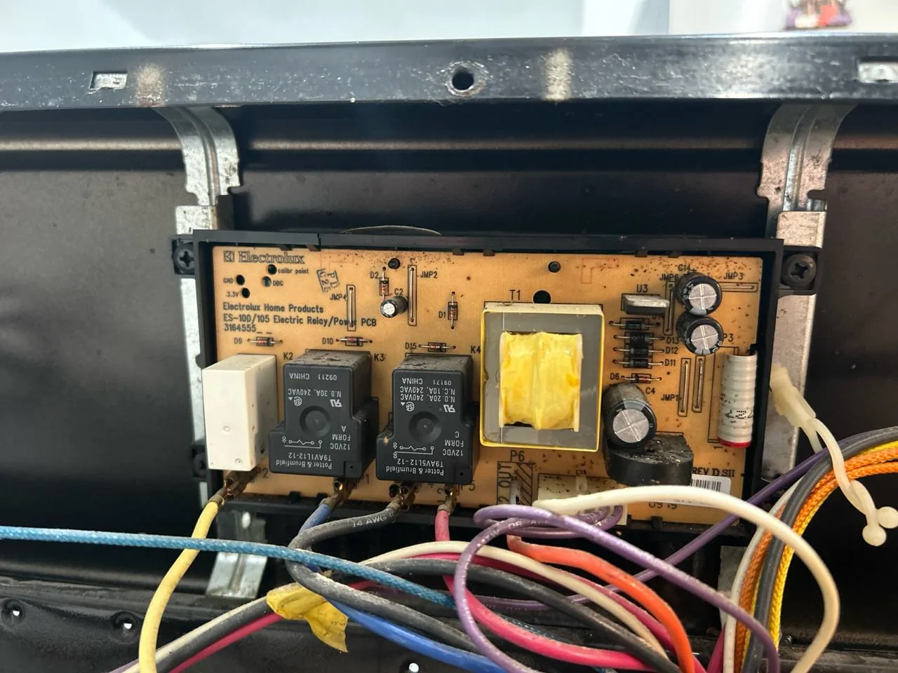 Close-up of a control board with relays and wiring from an Electrolux appliance