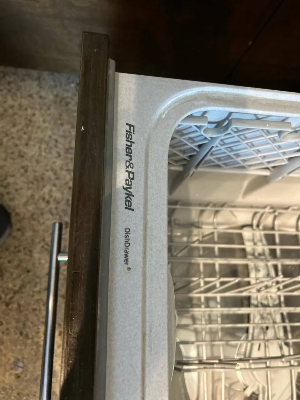 A Fisher & Paykel DishDrawer dishwasher with its rack visible