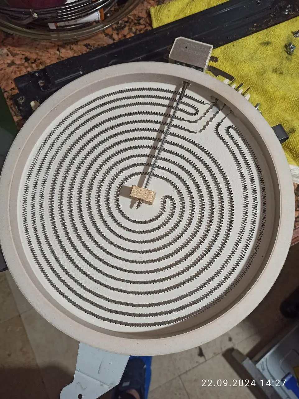 The a disassembled cooktop heating element on a countertop