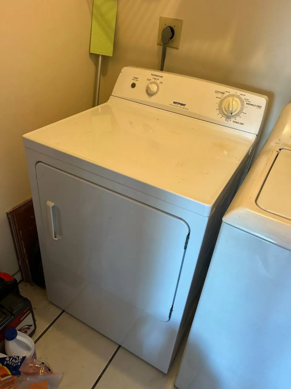 A white Hotpoint dryer next to another appliance