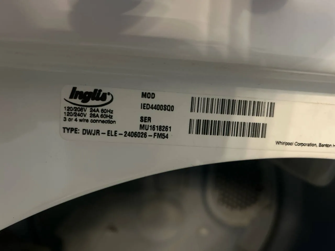 A close-up of an Inglis dryer's model and serial number tag, with 'TYPE: DWJR-ELE' visible