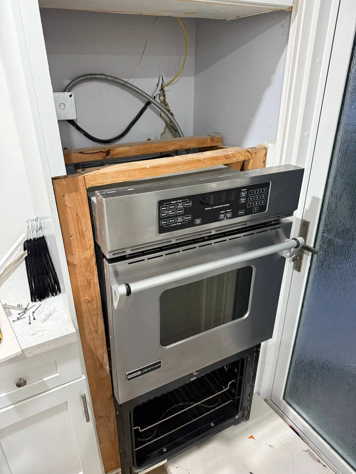 JennAir oven service: a Jenn-Air built-in oven partially installed, with exposed wiring above