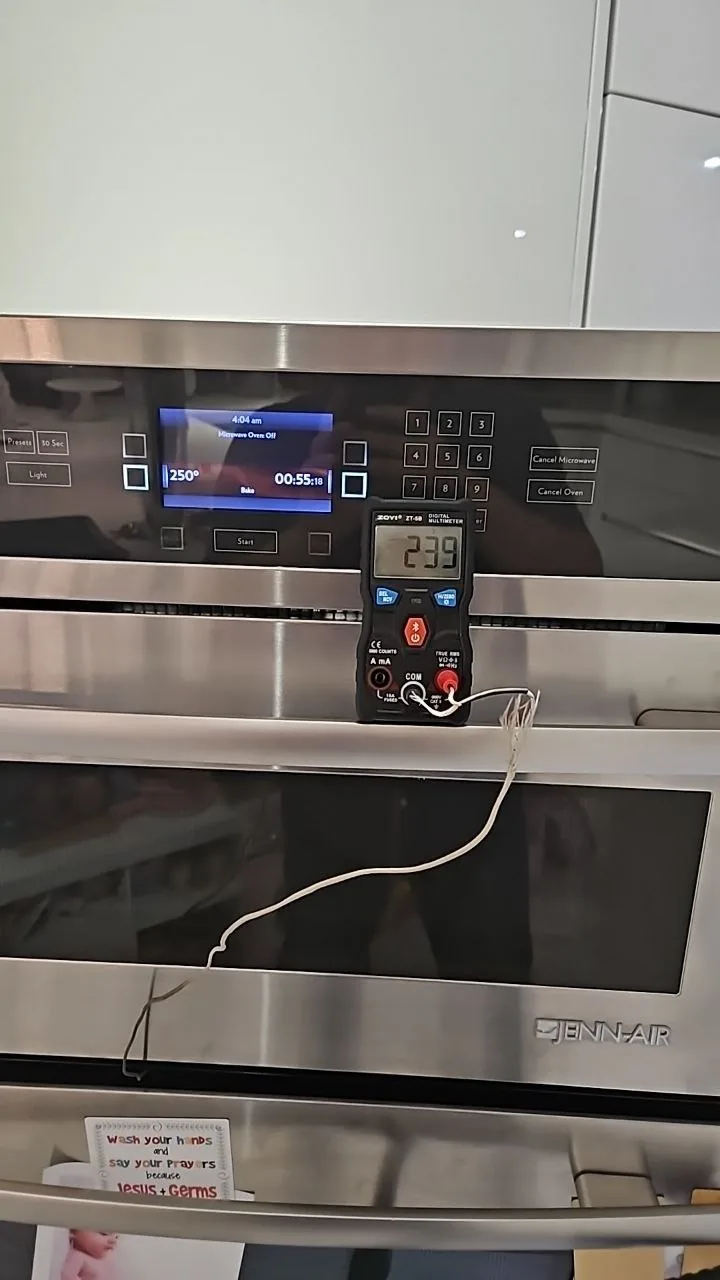 JennAir oven service: a multimeter is used to test the temperature of a Jenn-Air oven, which shows 239 degrees while the