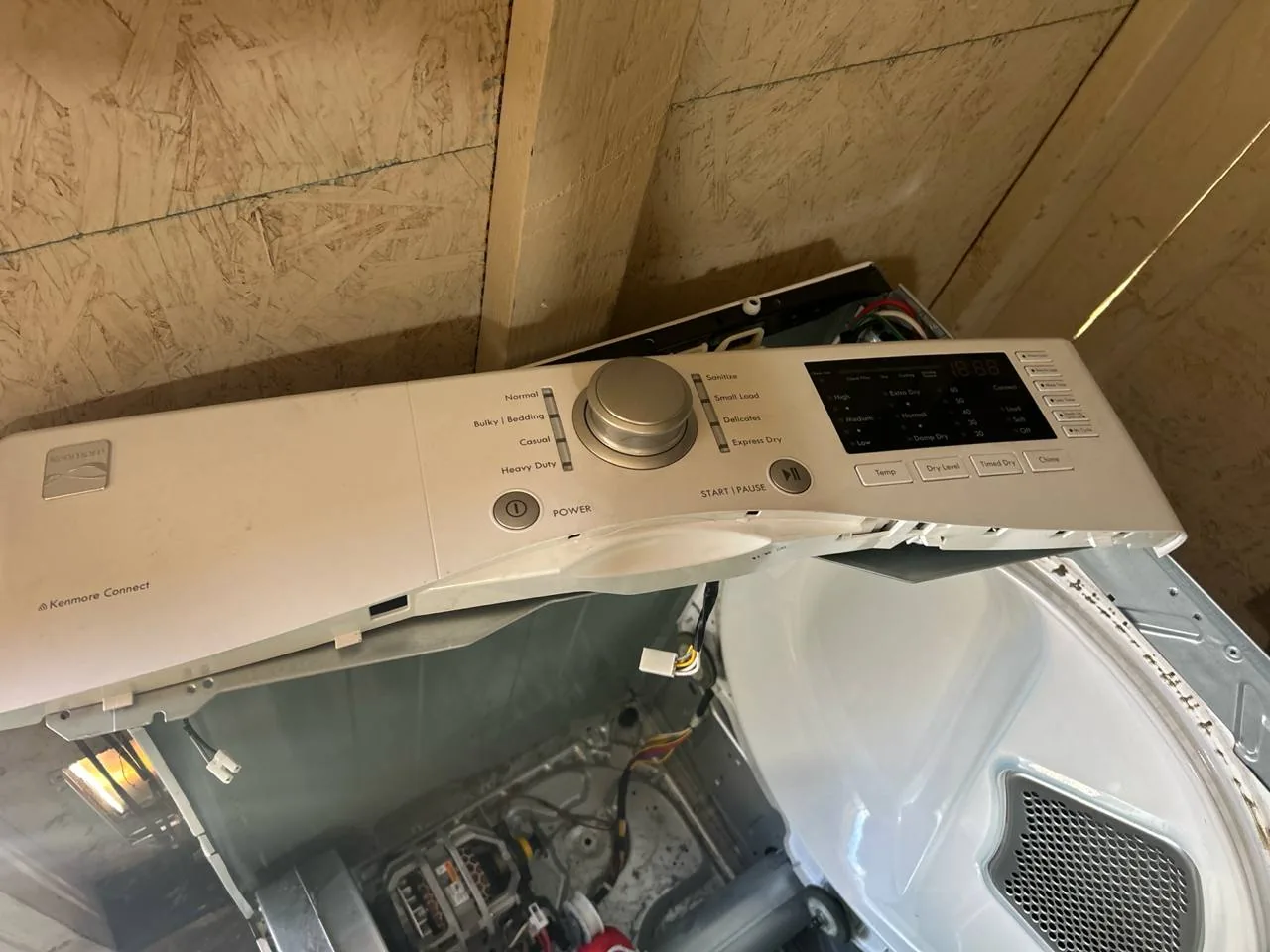 A disassembled Kenmore dryer with its control panel prominently displayed
