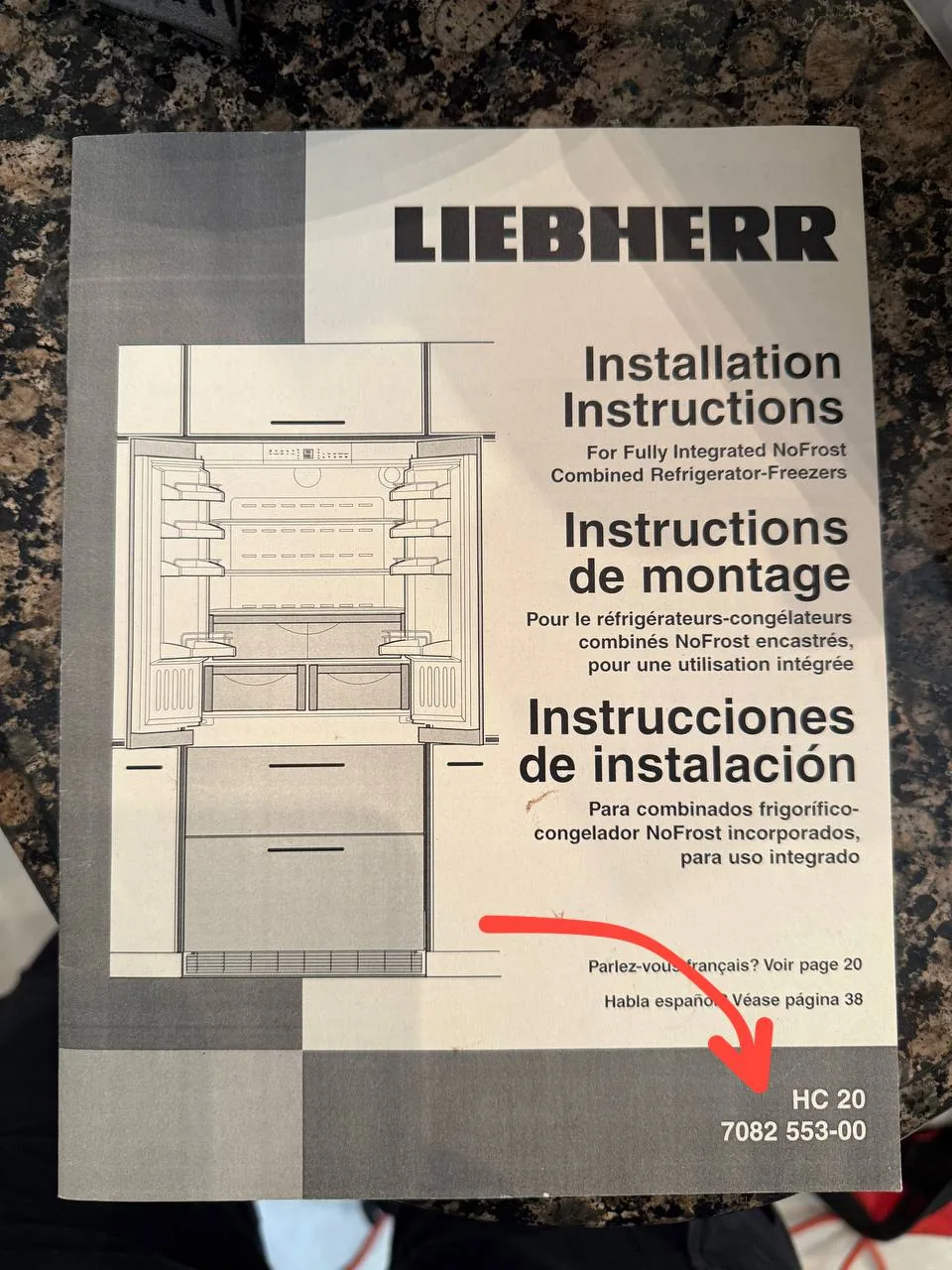 A Liebherr refrigerator installation instruction manual on a countertop