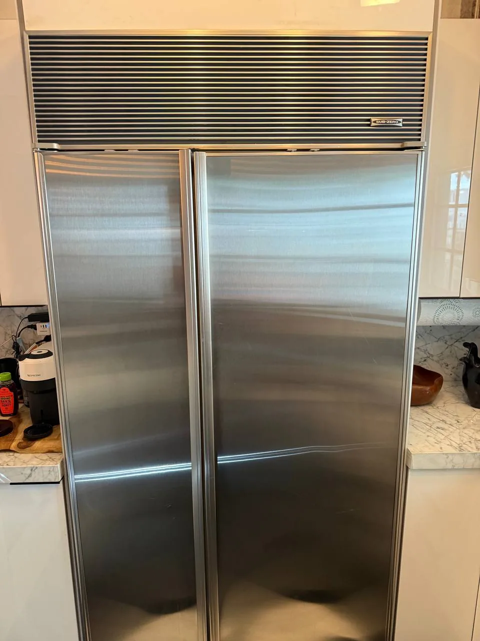 A stainless steel Sub-Zero refrigerator installed in a kitchen