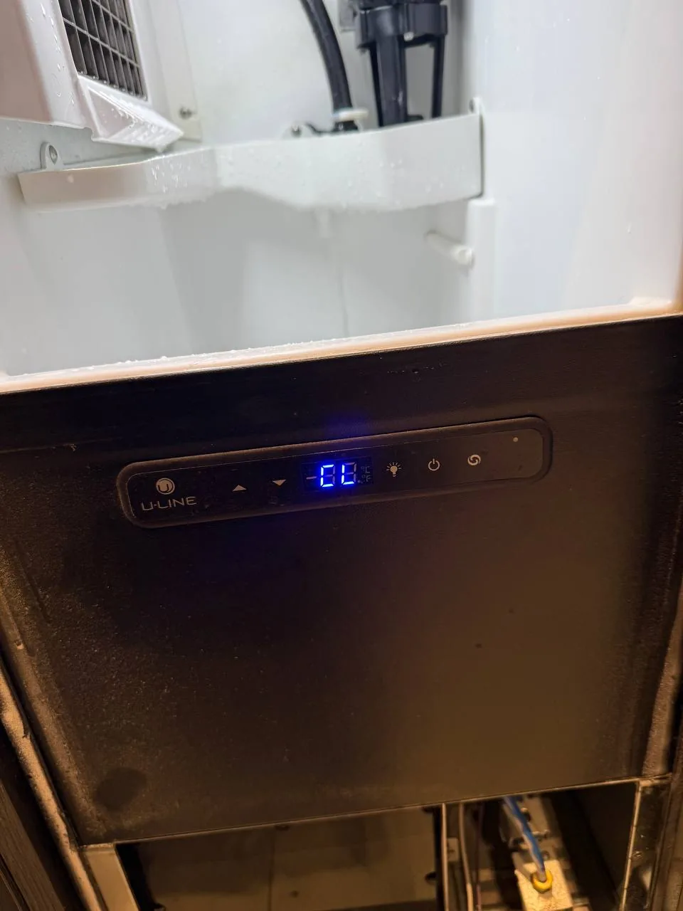 The the interior of a U-Line ice maker with a digital display showing '-00'