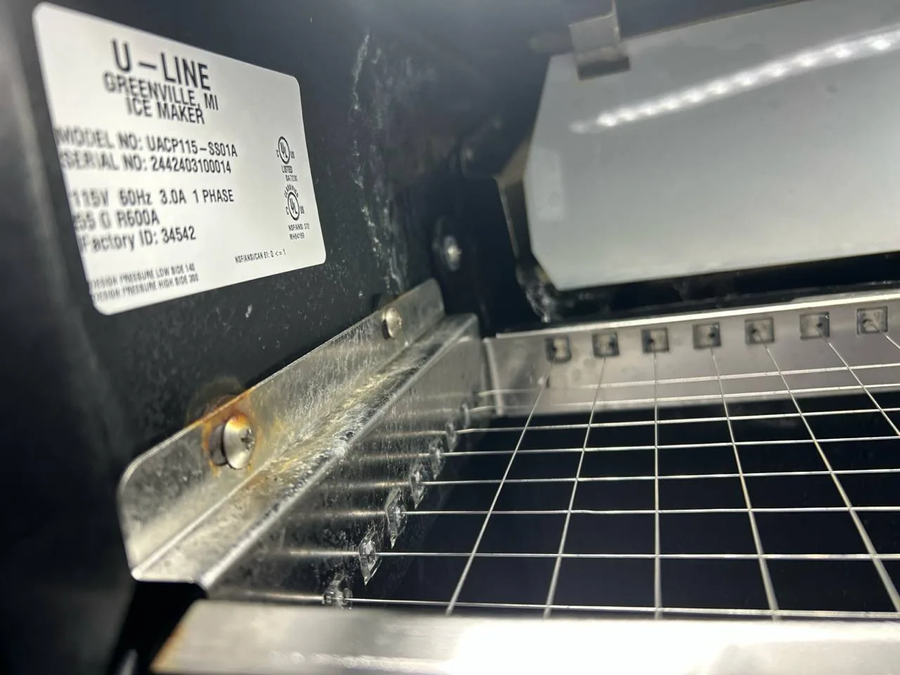 A U-Line ice maker label and internal components